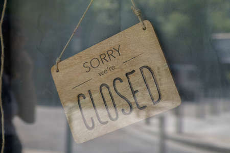 wood sorry we are closed sign board wooden vintage board on windows shop restaurant cafe store signboardの写真素材