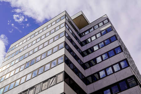 modern office and residential building facade against a nice blue white cloudy sky