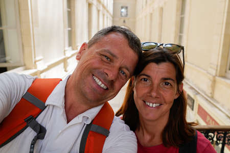 Loving cheerful happy couple taking selfie in Nantes city vacation