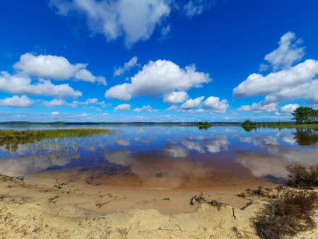 water sky and cloud reflection in blue summer at Lacanau lake in Franceの写真素材