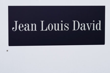 Bordeaux, Aquitaine / France - 11 08 2020: Jean Louis David logo and text sign front of barber shop...