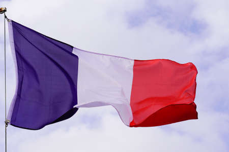 flying red blue white French flag on summer sky