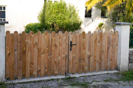 Brown natural wooden gate door of private house in street view