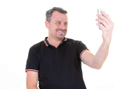 portrait of happy handsome man smiling toothy smile looking at the camera making selfie portrait...