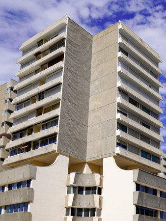 apartment building on sunny day with a blue cloudy skyの写真素材