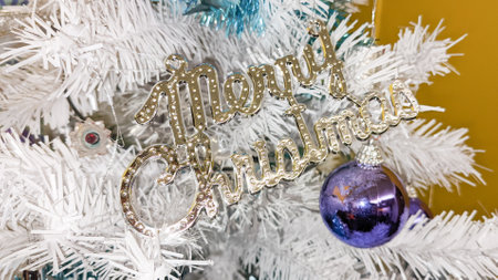 Merry Christmas silver text on white tree pineの写真素材