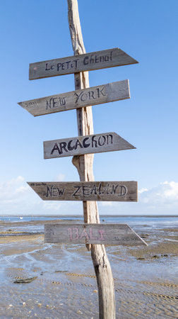 wood beach post with different wooden signboards pointing to various destinations in arcachon bay Franceの写真素材