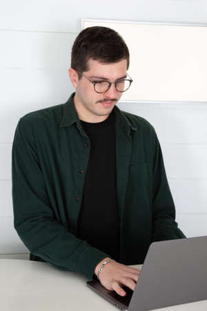 mustache brown hair handsome man business trainer over white background front of desk in officeの写真素材
