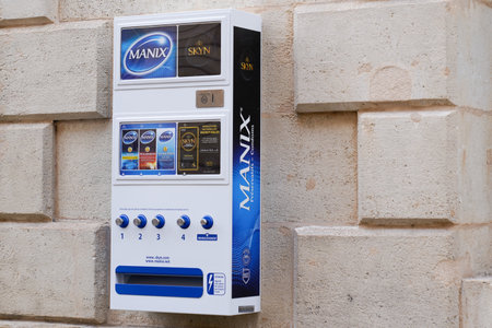 Bordeaux, Aquitaine France - 02 16 2021: manix condoms automat machine on pharmacy street building wall facade with sign logoのeditorial素材