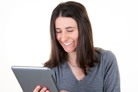 Portrait of pretty charming confident trendy woman with computer tablet in hands isolated on white...