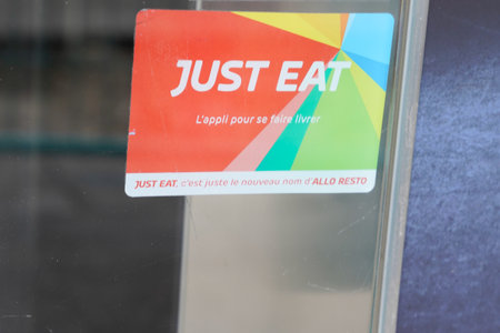 Bordeaux, Aquitaine France - 03 03 2021: just Eat sign brand and french text logo on windows entrance restaurant of application food deliveryのeditorial素材