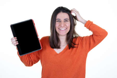 Woman happy smiling showing blank black tablet computer empty screenの写真素材