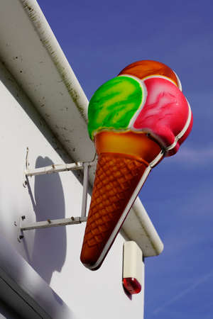 giant ice cream waffle sign cone hanging from a shop