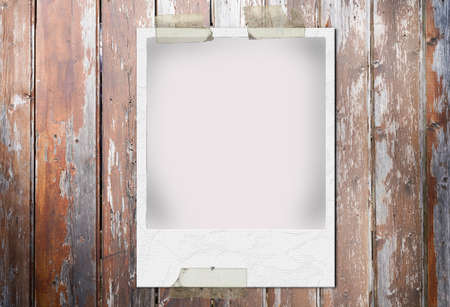 Blank white photo printing tape on a old used brown wooden background with ancient photographic...