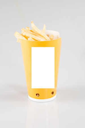 French potato pack box fries in yellow paper cup Take it away with blank sheet paper for text mock up empty white space for brand isolated on backgroundの写真素材