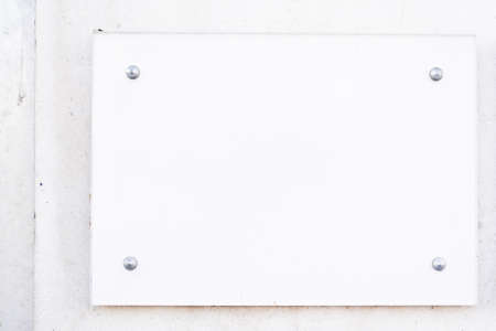 Wall mockup with blank white empty signage plate ready for your artwork sign with mock up company name on facadeの写真素材