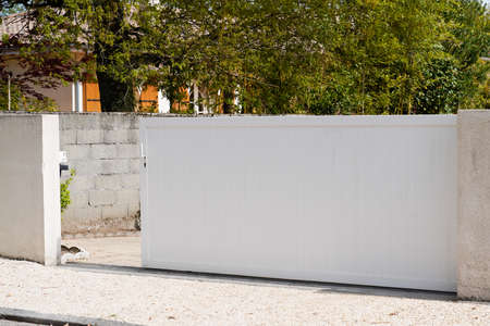 private gate open in white modern portal aluminum steel door in street view of suburbs house