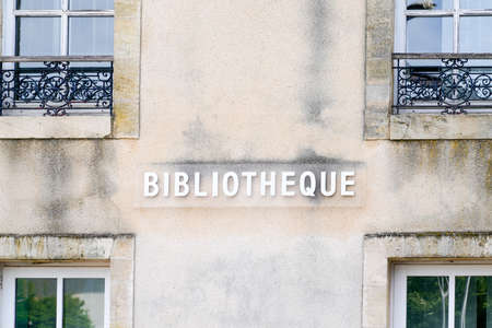 bibliotheque sign french text on facade of Old French Village Building Municipal Library in city centerの写真素材