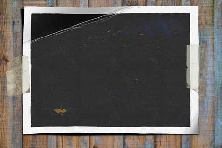 mock up photo on old wooden wall with adhesive tapeの写真素材