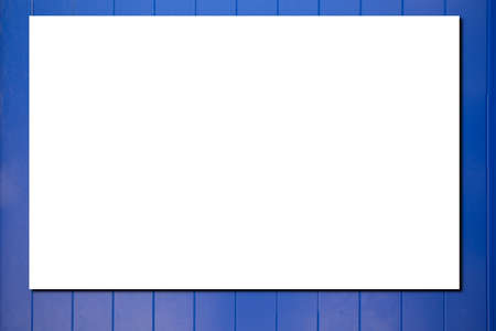 Real blank paper sheet with shadow on blue plank wooden backgroundの写真素材