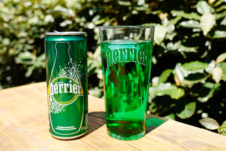 Bordeaux, Aquitaine France - 06 06 2021: Perrier sign and text brand on metal can with a glass of...