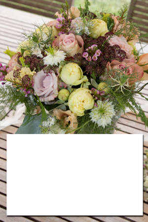 Wedding birthday mock-up card with white blank paper sheet greeting card invitation with marriage decorative floral composition bouquet flowersの写真素材