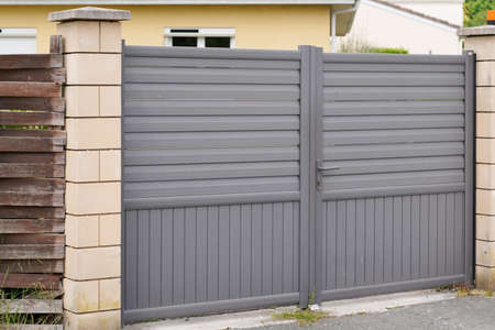Aluminum fence modern home gray steel gate high portal of suburb house door