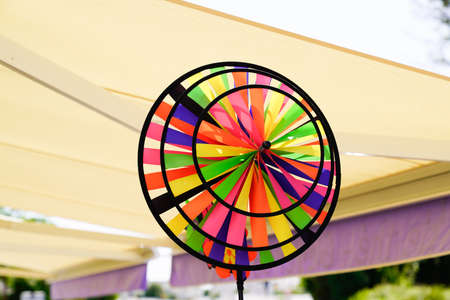 Colorful pinwheel in city street for children wheels play wind in plastic