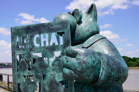 Bordeaux, Aquitaine France - 07 25 2021: Exhibition Le chat deambule statue sculpture The cat walks reading newspaper in Bordeaux by Philippe Geluck belgium cartoonistのeditorial素材