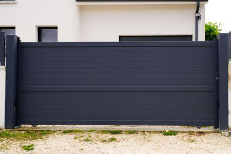 modern gray slide gate aluminum portal outdoor suburbs house streetの写真素材