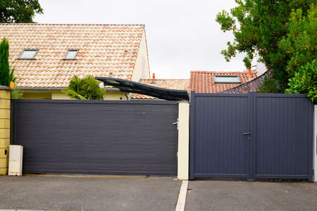 street suburb home gray dark metal aluminum double leaf carriage and sliding house gatesの写真素材
