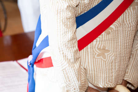 French mayor woman with a scarf flag in city hall during official celebration in france townの写真素材
