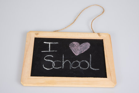 school old retro blackboard and white chalk text i love on gray backgroundの写真素材