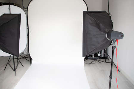 white empty setup photographer modern photo studio room with professional light equipment mockupの写真素材