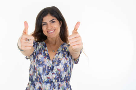 happy woman giving thumbs up fingers over white background copy spaceの写真素材