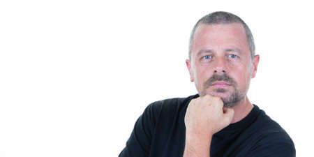 Portrait of handsome pensive middle aged man hand on chin on white backgroundの写真素材