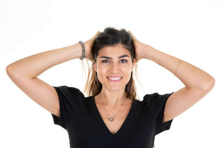 young happy woman smiling two hand in hair on white background