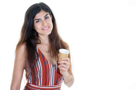 Young woman smiling holding hot cup take away distributor of coffee in hand isolated aside copy...