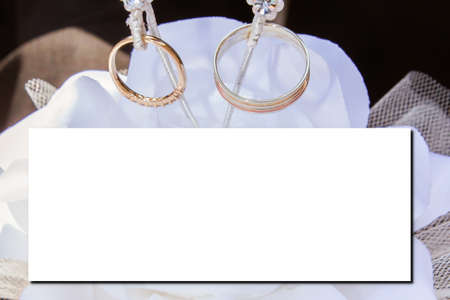 wedding empty invitation template mockup white blank paper Top view card with golden rings marriage backgroundの写真素材