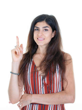 happy smiling woman over isolated white background pointing finger to top up sideの写真素材