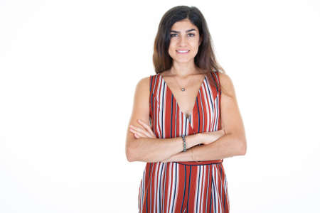 Pretty woman with long hair dressed casually looking smiling camera arms crossed aside copyspaceの写真素材