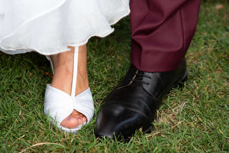 Feet shoes footwear of the groom and the bride closeup weddingの写真素材