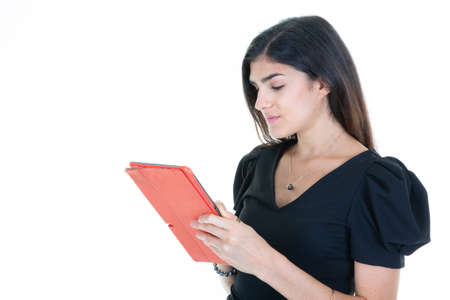 confident woman in classic black shirt looking tablet computer in hands isolated on white background