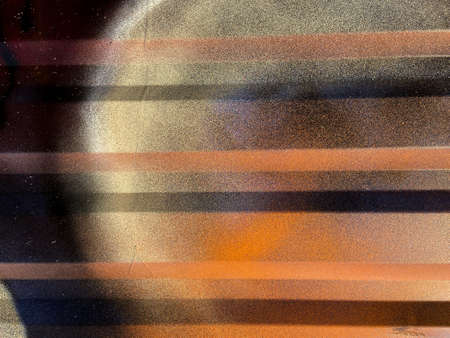 Artistic golden yellow colorful ink paint drips detail on metallic textured background of industrial...