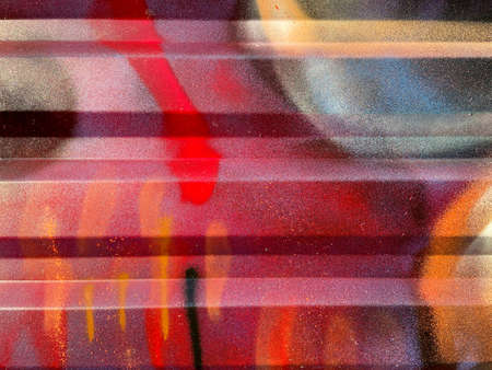 Colorful graffiti background markings on metallic wall steel shutter close up