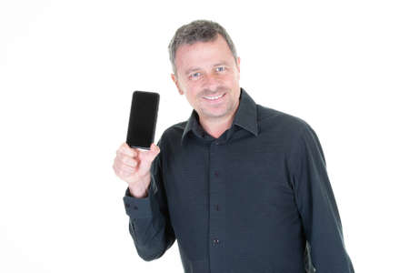 Cheerful handsome man presenting black empty screen smartphone mockupの写真素材