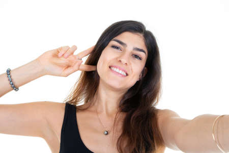 young girl happy beautiful smiling woman taking a selfie with phone cellの写真素材