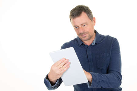 middle aged man in casual blue shirt using tablet computer over white background