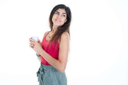 pretty girl profile young woman holding cup of coffee in white backgroundの写真素材