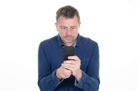handsome middle aged man looking at the screen of his cell phone
